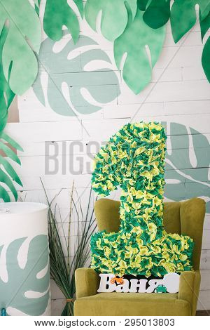Bulk Figure One Green Color Stands On A Chair Next To The Word Vanya On A White Background With Mans