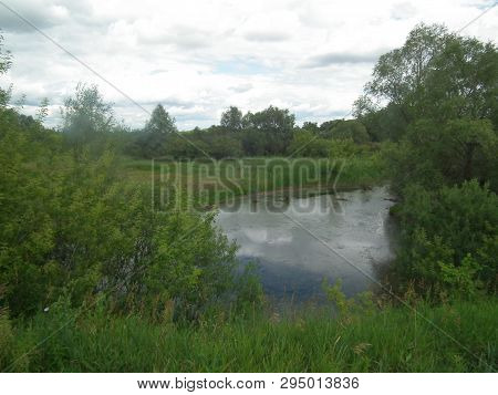 Rural Landscape. View Of A Small Village River .