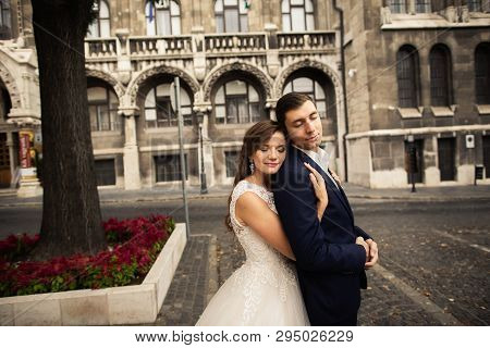 Bride And Groom Hugging In The Old Town Street. Weding Couple In Love. Weeding In Budapest.