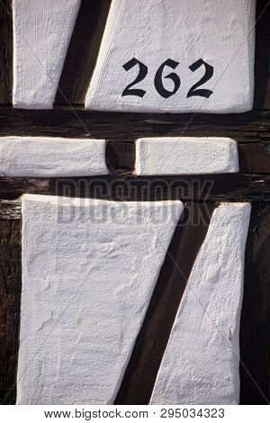 The Beam Construction And The Facade Of A Half-timbered House Via Close-up With House Number.