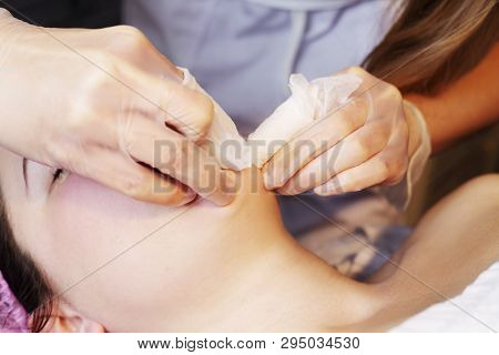 Depilation With Hot Wax Mustache In The Beauty Salon. Young Woman Receiving Facial Epilation Close U