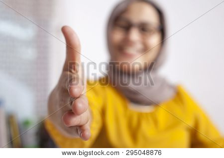 Portrait Of Muslim Businesswoman Offers Hand Shake, Deal Partnership Agreeement Concept, Selective F