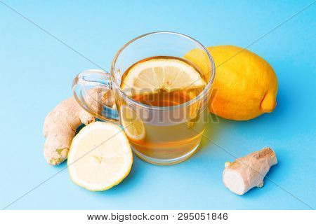 Tea, Lemon And Ginger On A Blue Background. Concept Helth And Theatment
