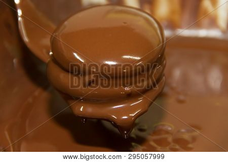 Preparation Of Alfajores Of Dulce De Leche Bathed In Chocolate