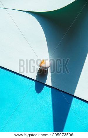 Artistic background with a glass marble with intrasting shadows. 