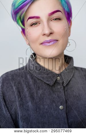 A Young Woman With Short Hair, A Pixie Bob Haircut, Different Colored Hair, Blue, Green, Violet.