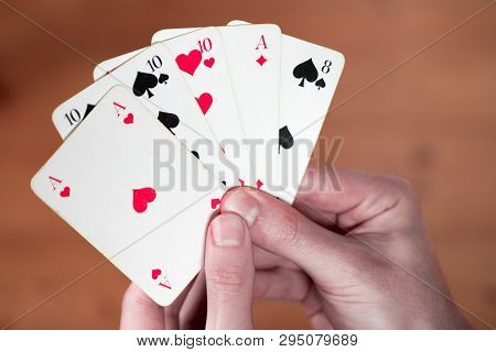 Playing Cards: Poker Cards In The Hand Of A Man