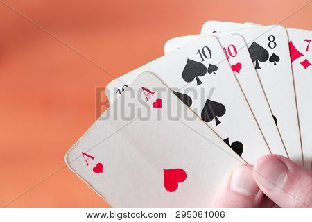 Playing Cards: Poker Cards In The Hand Of A Man