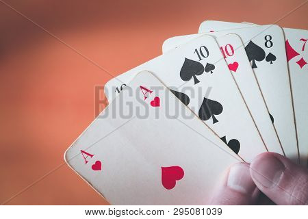 Playing Cards: Poker Cards In The Hand Of A Man