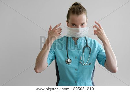 Woman Laborant Working With Microscope Holding Automatic Pipette