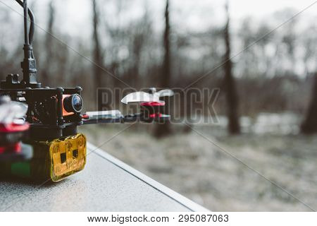 Fpv Drone Lies On The Table. The Pilot Sets Up His Racing Drone Before The Flight.