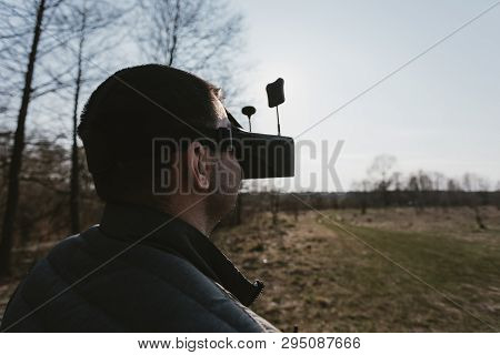 Fpv Drone Pilot In A Virtual Reality Helmet With A Remote Control From A Copter Flies In Aircraft Ou