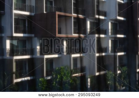 Black See Through Curtains With Blurred Building Background Through Window Frame. Selective Focus On