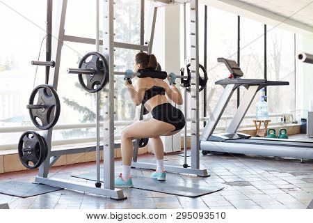 Strong Tough Sportswoman Does Back Squats Looking Out Of Window, Developing Her Muscles. Young Black