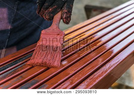 House Painter Paints Metal Structures. Protective Coating Of Steel Closed Profiles With Primer Iron 