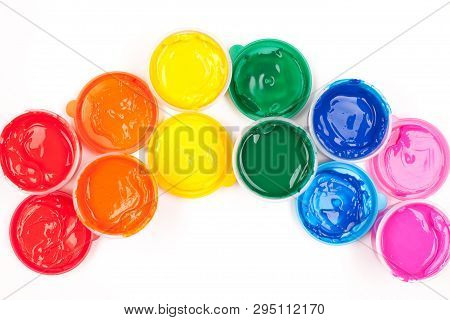 Motley Paints On The White Background. Paints Arranged As Rainbow. Studio Shot