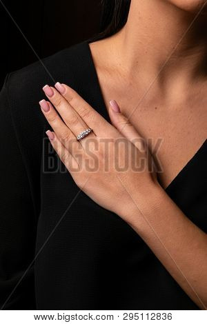Womens Silver Diamonds Ring With A Fringe On Finger, On A Black Background.