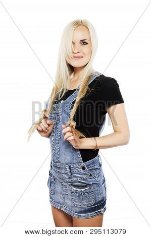 Portrait Of A Smiling Next Door Girl In Country Style Clothes Over White Background. Studio Shot