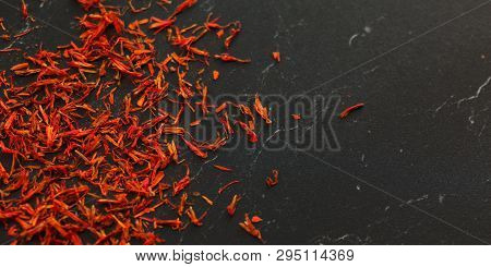 Saffron Crocus Crimson Stigmata And Styles Threads Used As Spice, On Black Marble Like Working Board