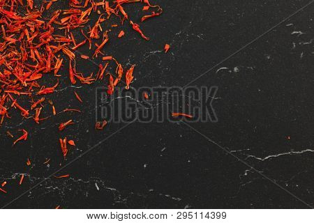 Saffron Crocus Crimson Stigmata And Styles Threads Used As Spice, On Black Marble Board, Flay Lay Ph