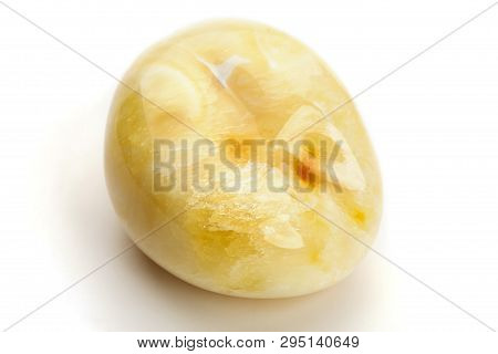 Natural Amber. A Piece Of Yellow Opaque Natural Amber On White Background.