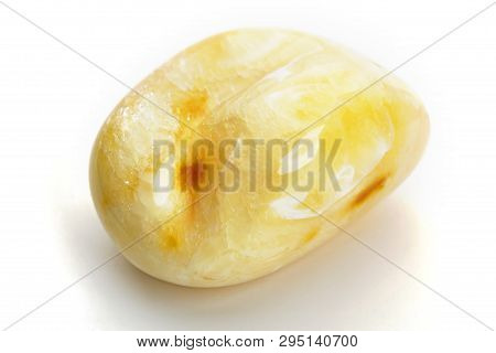 Natural Amber. A Piece Of Yellow Opaque Natural Amber On White Background.