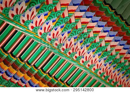 Colorful Wooden Beams Supporting Korean Traditional Temples Roofs And Showing Repeated Patterns