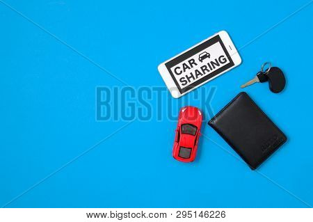 Car Sharing Concept With Toy Car, Auto Drive License, Car Key, Smartphone, Text Sign 