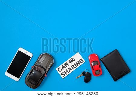 Car Sharing Concept. Composition With Driver's License, Vehicle Key, Toy Cars, Text Sign 