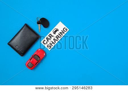 Car Sharing Concept. Composition With Driver's License, Vehicle Key, Toy Car, Text Sign 