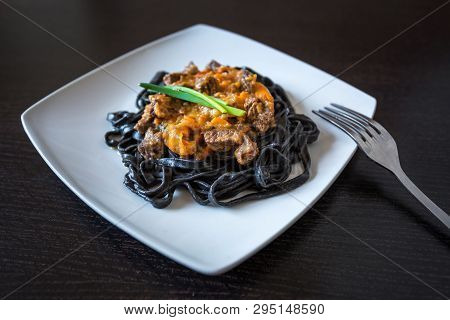 Black Pasta With Cuttlefish Ink. Pasta Of Durum Wheat Semolina With Squid Ink With Beef And Sweet Pe
