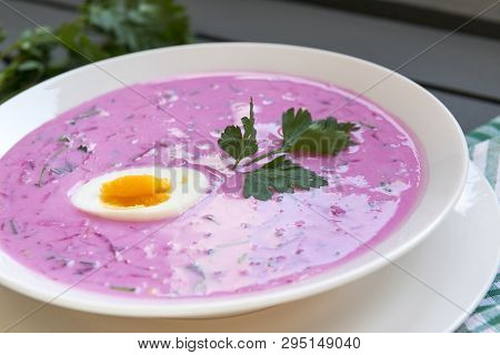 Pink Soup, Cold Beet Soup With Egg And A Sprig Of Parsley, Cold Soup With Greens In A White Plate