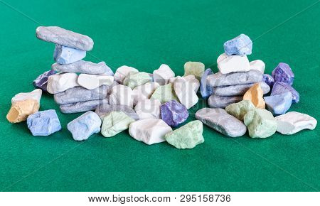 Stacks And Pile From Various Multicolored Stones On Green Baize Table