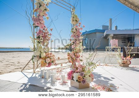 Event Decoration. Wedding Chuppa At Riverside Decorated With Fresh Flowers. Florist Workflow.