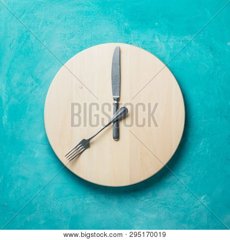 Intermittent Fasting And Skip Breakfast Concept - Empty Wooden Round Tray Or Trencher With Cutlery A