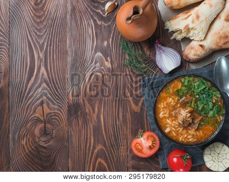 Traditional Georgian Kitchen Kharcho Soup With Meat, Rice, Fresh Cilantro.spicy Soup Kharcho On Wood