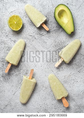 Homemade Raw Vegan Avocado Lime Popsicle. Sugar-free, Non-dairy Green Ice Cream On Gray Background. 