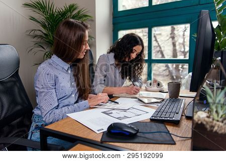 Handsome Women Architects In Blue Shirts Working With Color Palatte To Choose Design And Colors On T