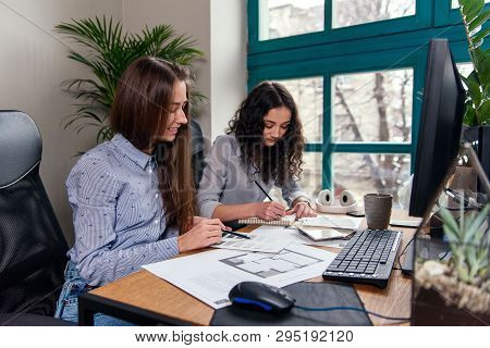 Handsome Women Architects In Blue Shirts Working With Color Palatte To Choose Design And Colors On T