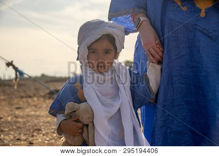 Little Girl In Arabic Dress Holding Mother's Hand