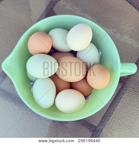 A Dozen Farm Fresh Eggs In A Jadeite Bowl.
