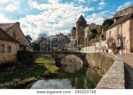 View Of The Ancient City Of Semur-en-osua. There Is A Quay, A Stone Bridge, Walls And Towers Of The 