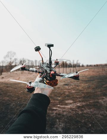 Pilot Racing Drone Holds In His Hand Fpv Copter Before Launching It. A Small High-speed Aircraft Wit
