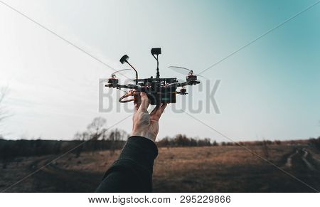 Pilot Racing Drone Holds In His Hand Fpv Copter Before Launching It. A Small High-speed Aircraft Wit