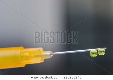 Macro View Of A Hypodemic Needle With Two Drops Of Drug Solution On His Peak