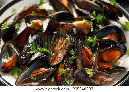 Mussels With White Wine, Garlic, Lemon And Herbs In A Plate, French Fries. Rustick Background. Seafo