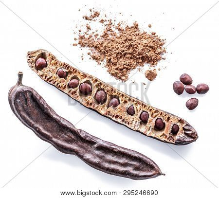 Carob pods and carob powder on the white background.