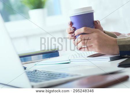 Morning Coffee Before A Productive Working Day. Young Female Office Worker Holding Coffee Papercup A