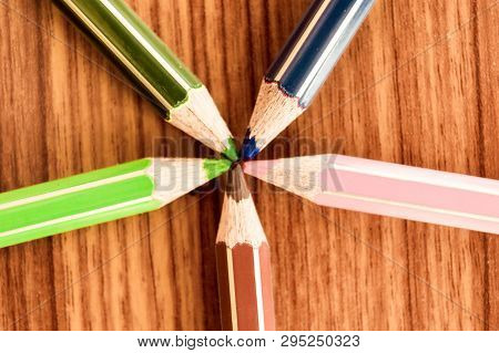 Symbolical Image Central Power Meeting At A Point. Close-up Of A Selection Of Multi Colored Pencils 