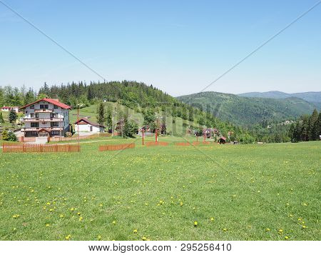 Houses In Quite Landscapes Of Grassy Field And Forest At Beskid Mountains Range In European Salmopol